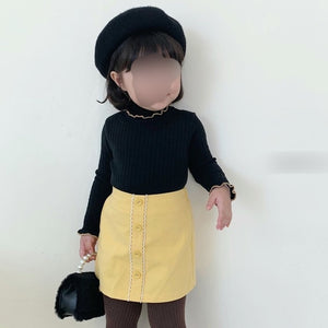 Black sweater + yellow skirt