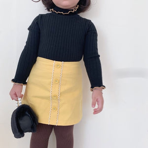 Black sweater + yellow skirt